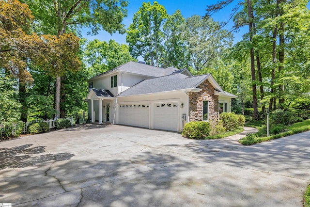 118 Pinnacle Pointe Dr, Seneca, SC 29672 - view of property exterior featuring stone siding, an attached garage, stucco siding, concrete driveway, and a shingled roof