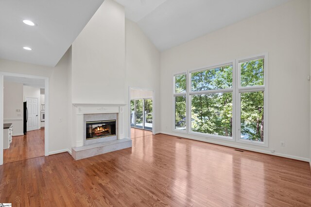118 Pinnacle Pointe Dr, Seneca, SC 29672 - unfurnished living room with high vaulted ceiling, a premium fireplace, wood finished floors, and recessed lighting