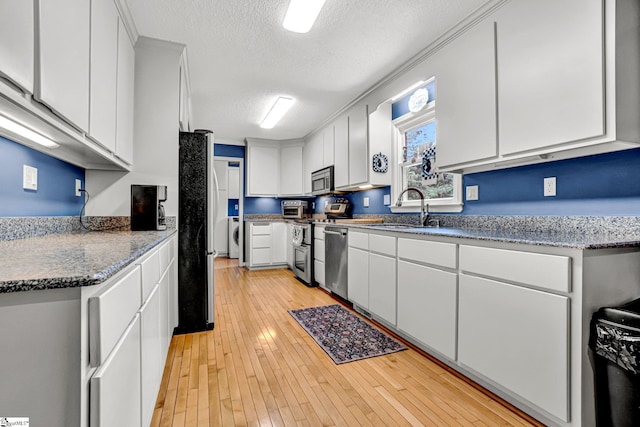203 Ponder Rd, Greer, SC 29651 - kitchen featuring stainless steel appliances, a textured ceiling, light wood finished floors, white cabinets, and stone countertops