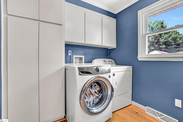 203 Ponder Rd, Greer, SC 29651 - laundry area with cabinet space, washer and clothes dryer, light wood-style floors, and ornamental molding