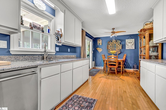 203 Ponder Rd, Greer, SC 29651 - kitchen featuring stainless steel dishwasher, a textured ceiling, ceiling fan, white cabinets, and light wood-type flooring