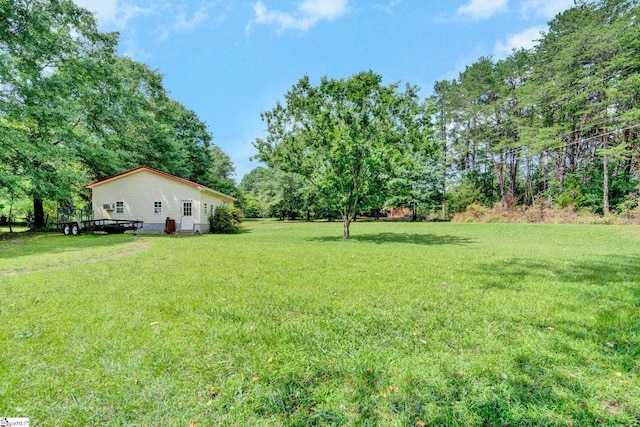 203 Ponder Rd, Greer, SC 29651 - view of green lawn featuring a deck and view of wooded area