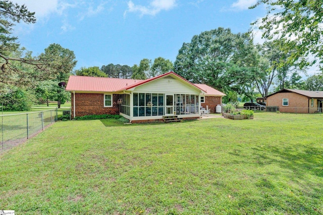 203 Ponder Rd, Greer, SC 29651 - back of property with a sunroom, brick siding, a fenced backyard, and a metal roof