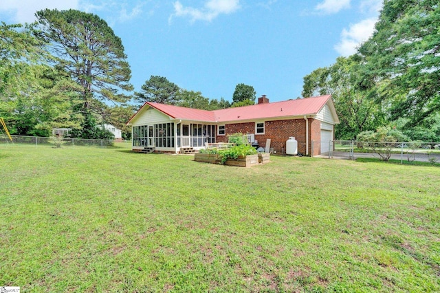203 Ponder Rd, Greer, SC 29651 - rear view of property featuring a sunroom, a fenced backyard, a chimney, and an attached garage