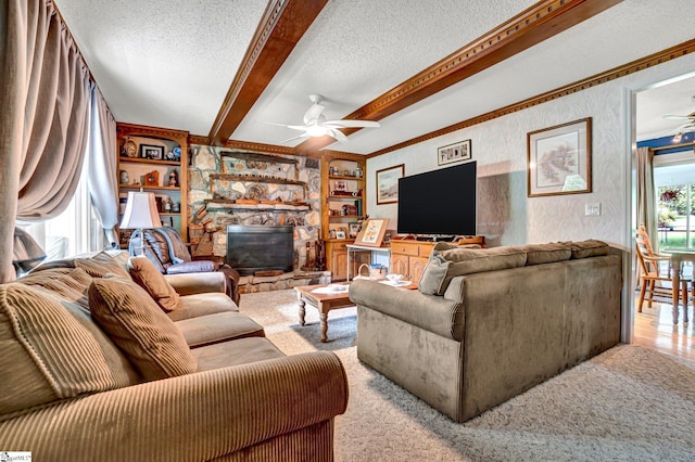203 Ponder Rd, Greer, SC 29651 - living room with ceiling fan, a textured ceiling, beamed ceiling, a stone fireplace, and carpet flooring