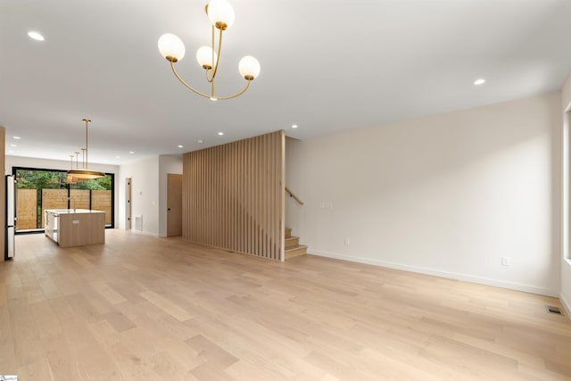 18 Nordic Ln, Greenville, SC 29609 - unfurnished living room with light wood finished floors, stairway, recessed lighting, and a chandelier