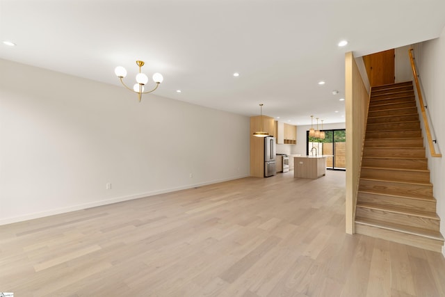 18 Nordic Ln, Greenville, SC 29609 - unfurnished living room with recessed lighting, light wood finished floors, stairway, and a chandelier