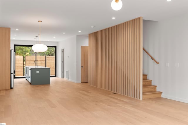 20 Nordic Ln, Greenville, SC 29609 - unfurnished living room with light wood-style flooring, recessed lighting, and stairs