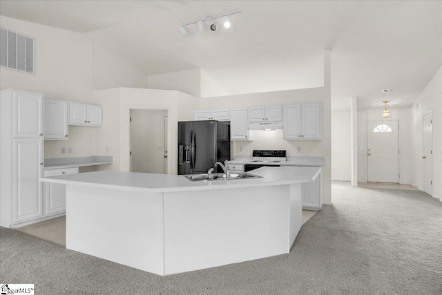 2013 Small Meadows Ct, Fountain Inn, SC 29644 - kitchen featuring black fridge, white range with electric cooktop, light colored carpet, under cabinet range hood, and light countertops