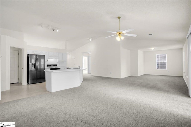 2013 Small Meadows Ct, Fountain Inn, SC 29644 - unfurnished living room with plenty of natural light, vaulted ceiling, ceiling fan, and light carpet