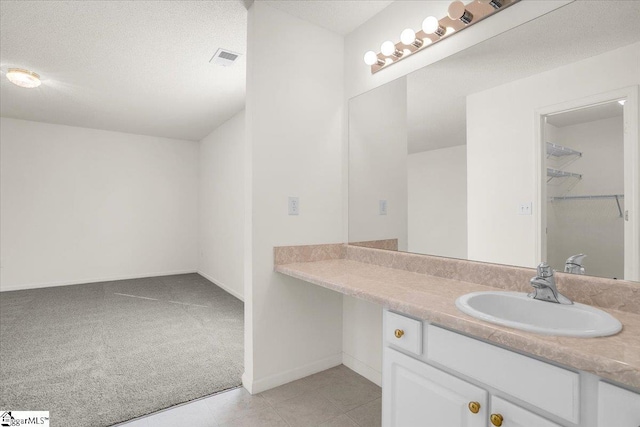 2013 Small Meadows Ct, Fountain Inn, SC 29644 - bathroom with vanity, a walk in closet, and tile patterned flooring