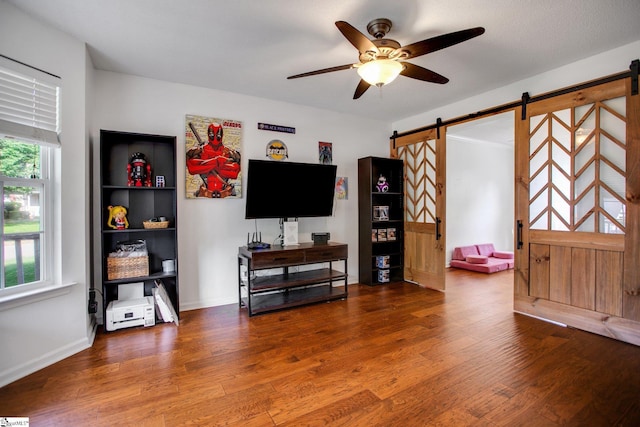 101 Bitternut Ln, Taylors, SC 29687 - living area with a barn door, a ceiling fan, and wood finished floors