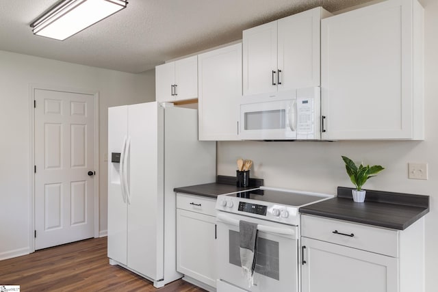 310 W Bushy Hill Dr, Duncan, SC 29334 - kitchen with white appliances, dark countertops, dark wood-style flooring, white cabinetry, and a textured ceiling