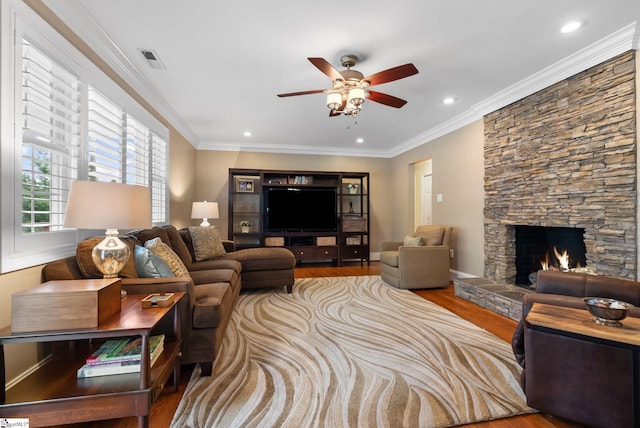 103 Crestview Cir, Greer, SC 29651 - living room with wood finished floors, a ceiling fan, ornamental molding, a stone fireplace, and recessed lighting