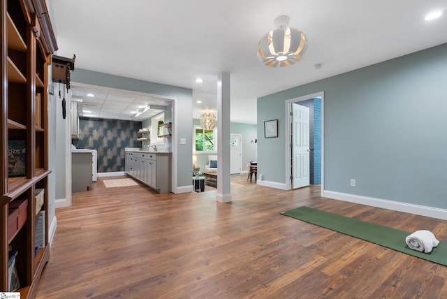 103 Crestview Cir, Greer, SC 29651 - unfurnished living room with wood finished floors, a barn door, recessed lighting, and an accent wall