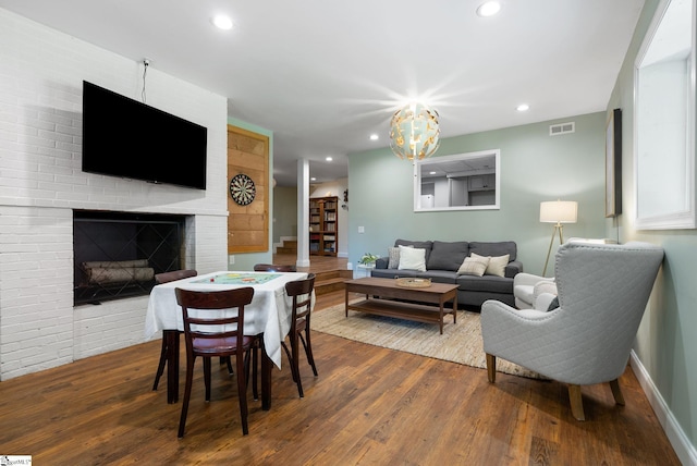 103 Crestview Cir, Greer, SC 29651 - living room with wood finished floors, a brick fireplace, a chandelier, and recessed lighting