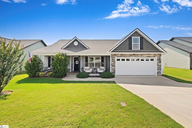 257 Highland Springs Loop, Inman, SC 29349 - view of front facade with driveway, a front yard, a porch, and stone siding