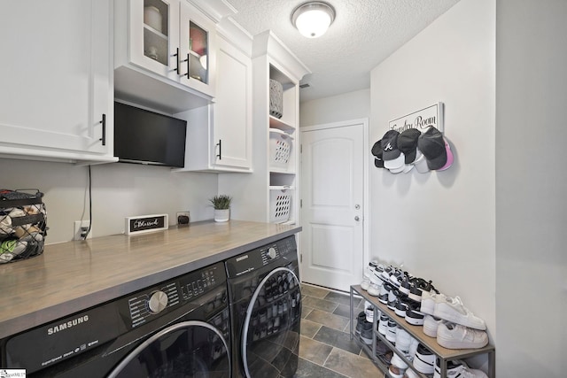257 Highland Springs Loop, Inman, SC 29349 - laundry room featuring cabinet space, washing machine and clothes dryer, stone finish floors, and a textured ceiling