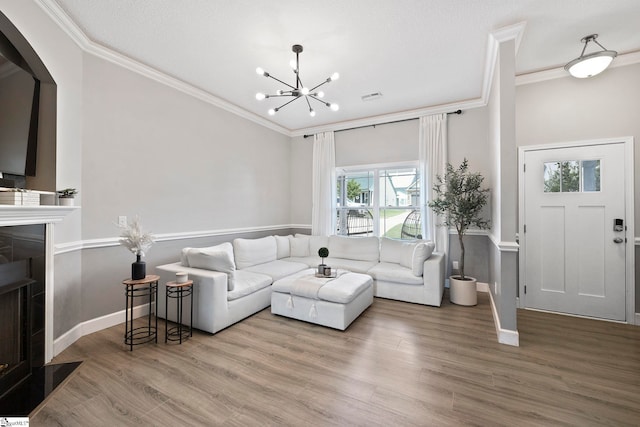 257 Highland Springs Loop, Inman, SC 29349 - living room with ornamental molding, a chandelier, a fireplace, wood finished floors, and arched walkways