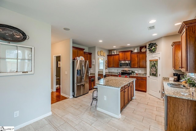 208 Castleton Cir, Boiling Springs, SC 29316 - kitchen with stainless steel appliances, a center island, a breakfast bar, light stone counters, and recessed lighting