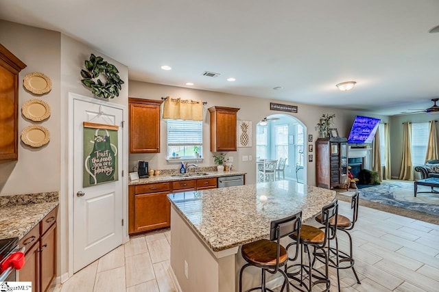 208 Castleton Cir, Boiling Springs, SC 29316 - kitchen featuring arched walkways, open floor plan, brown cabinets, a kitchen breakfast bar, and recessed lighting