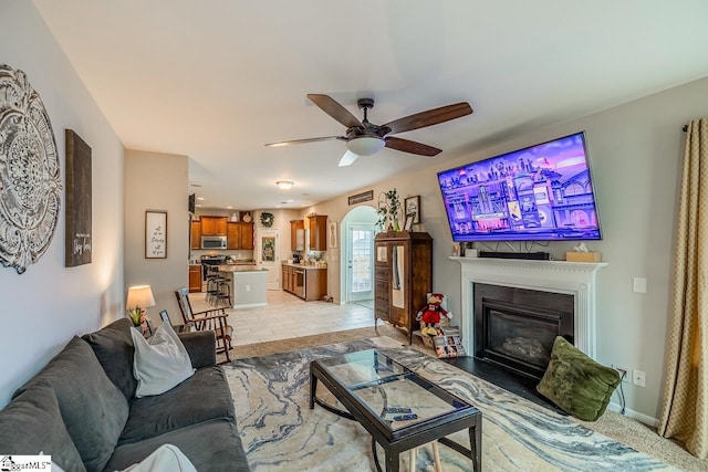 208 Castleton Cir, Boiling Springs, SC 29316 - living room featuring arched walkways, a ceiling fan, and a glass covered fireplace