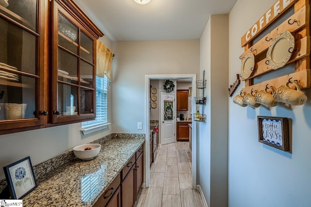 208 Castleton Cir, Boiling Springs, SC 29316 - kitchen with light stone countertops, glass insert cabinets, and wood tiled floors