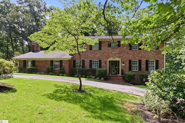 11 Elmwood Dr, Taylors, SC 29687 - colonial-style house featuring a front yard, brick siding, and a chimney
