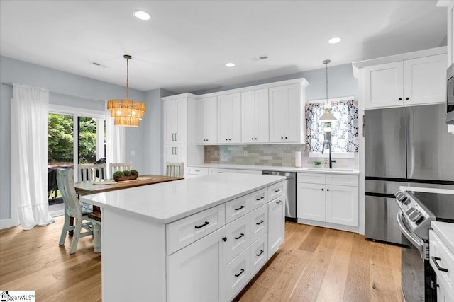 11 Echo Dr, Travelers Rest, SC 29690 - kitchen with stainless steel appliances, light countertops, a chandelier, white cabinets, and decorative backsplash