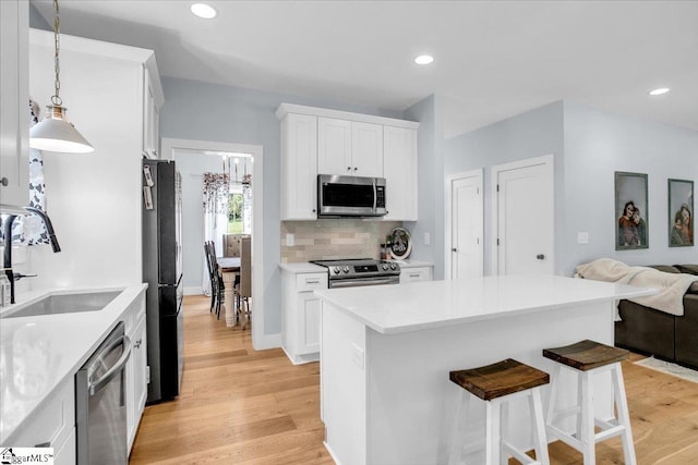 11 Echo Dr, Travelers Rest, SC 29690 - kitchen with stainless steel appliances, open floor plan, light wood-style flooring, a breakfast bar area, and recessed lighting