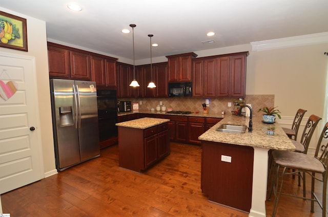 108 Dillard Creek Ct, Greer, SC 29651 - kitchen featuring black appliances, a peninsula, backsplash, light stone countertops, and dark wood-type flooring