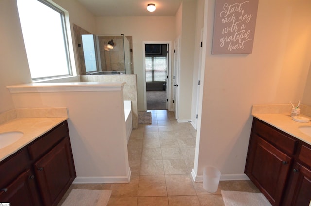 108 Dillard Creek Ct, Greer, SC 29651 - bathroom featuring tiled shower, tile patterned floors, a bath, and two vanities