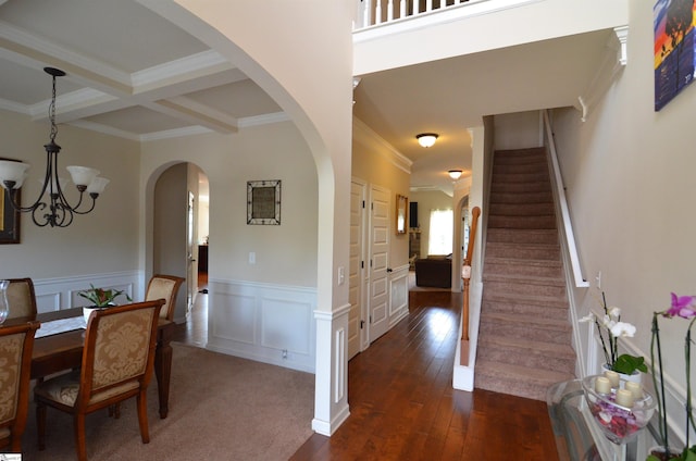 108 Dillard Creek Ct, Greer, SC 29651 - dining room with a chandelier, ornamental molding, stairs, dark wood-style floors, and arched walkways