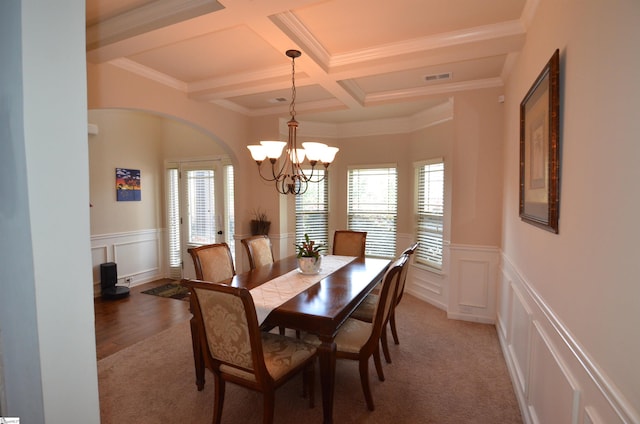 108 Dillard Creek Ct, Greer, SC 29651 - dining space with coffered ceiling, a decorative wall, beamed ceiling, a chandelier, and arched walkways