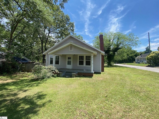 719 Chestnut St, Laurens, SC 29360 - bungalow-style house with a porch, a front lawn, and a chimney