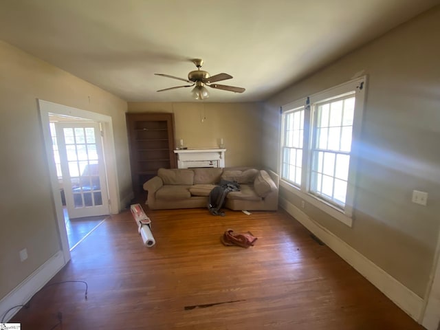 719 Chestnut St, Laurens, SC 29360 - living area featuring a fireplace, wood finished floors, and a ceiling fan