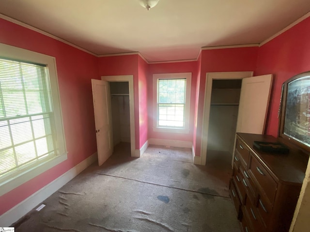 719 Chestnut St, Laurens, SC 29360 - unfurnished bedroom featuring light carpet, ornamental molding, and multiple closets