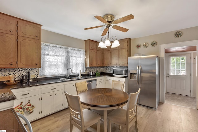 712 W Main St, Easley, SC 29640 - kitchen featuring appliances with stainless steel finishes, dark countertops, a ceiling fan, and light wood-style floors