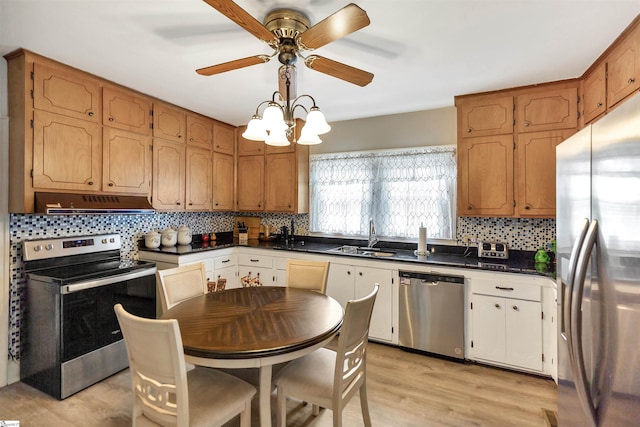 712 W Main St, Easley, SC 29640 - kitchen with appliances with stainless steel finishes, under cabinet range hood, dark countertops, decorative backsplash, and ceiling fan