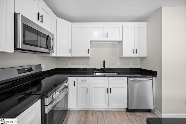1016 Scott Rd, Anderson, SC 29621 - kitchen with appliances with stainless steel finishes, white cabinetry, and light wood-type flooring