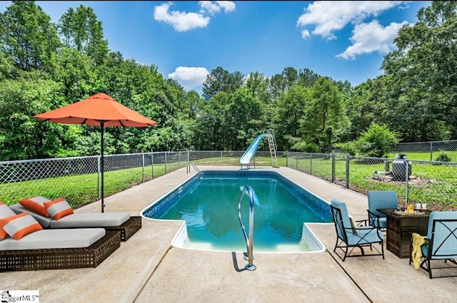 1016 Scott Rd, Anderson, SC 29621 - view of swimming pool featuring a water slide, a fenced backyard, a patio area, and view of scattered trees