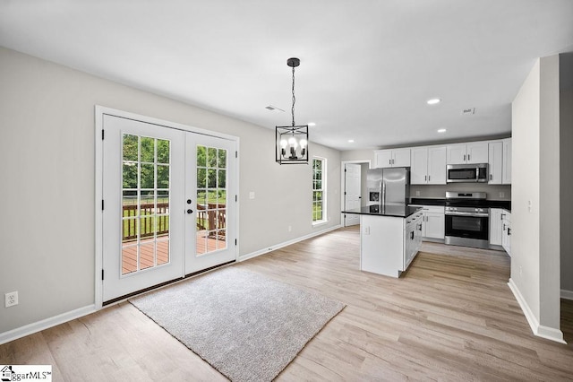 1016 Scott Rd, Anderson, SC 29621 - kitchen featuring stainless steel appliances, white cabinets, french doors, light wood-type flooring, and dark countertops