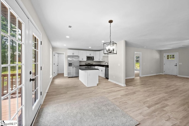 1016 Scott Rd, Anderson, SC 29621 - kitchen featuring appliances with stainless steel finishes, open floor plan, dark countertops, a chandelier, and white cabinets