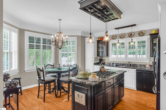 128 Banbury Cir, Simpsonville, SC 29650 - kitchen with black dishwasher, stainless steel gas stovetop, a chandelier, light wood-type flooring, and ornamental molding
