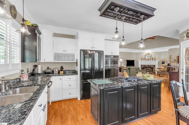 128 Banbury Cir, Simpsonville, SC 29650 - kitchen with stainless steel appliances, light wood-style flooring, white cabinets, crown molding, and lofted ceiling