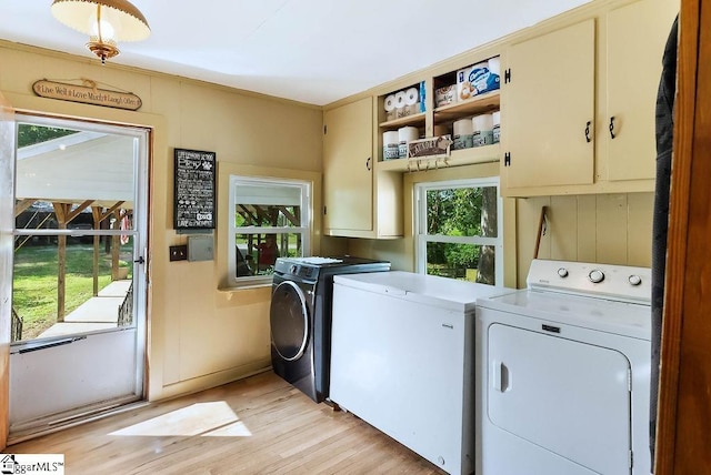 2115 Price House Rd, Woodruff, SC 29388 - washroom with separate washer and dryer, cabinet space, and light wood-type flooring