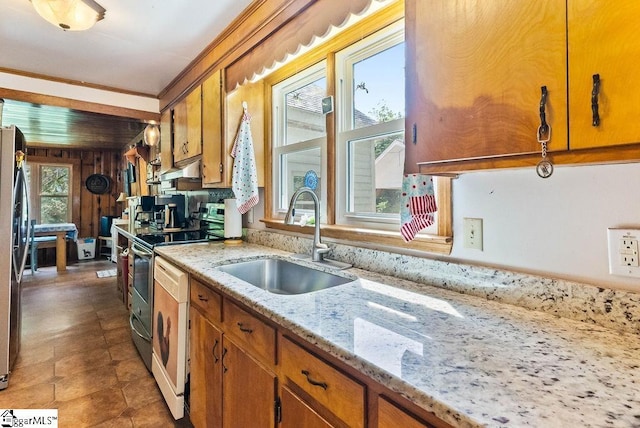 2115 Price House Rd, Woodruff, SC 29388 - kitchen featuring appliances with stainless steel finishes, brown cabinetry, ornamental molding, light stone counters, and under cabinet range hood