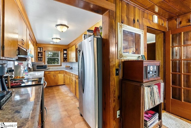 2115 Price House Rd, Woodruff, SC 29388 - kitchen featuring appliances with stainless steel finishes, under cabinet range hood, wood walls, open shelves, and light flooring