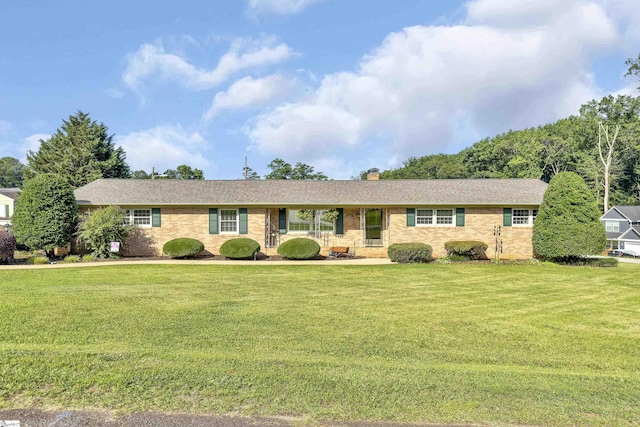 135 James Ave, Wellford, SC 29385 - single story home with a front lawn, a chimney, roof with shingles, and brick siding