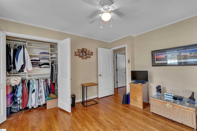 135 James Ave, Wellford, SC 29385 - bedroom with ornamental molding, light wood-type flooring, a closet, and ceiling fan